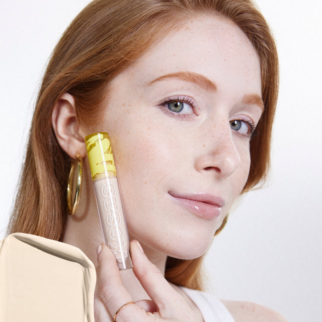 Model wearing Revealer Concealer in Tone 0.5 N