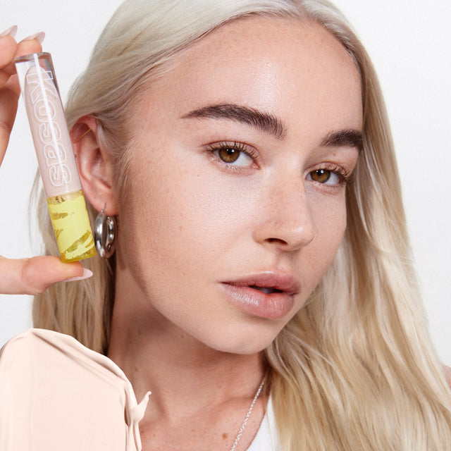 Model wearing Revealer Concealer in Tone 0.7 C