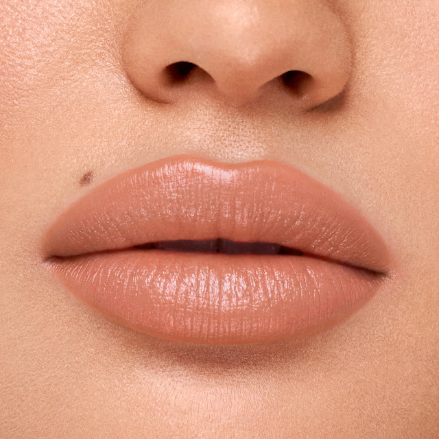 Medium skin tone model wearing Weightless Lip Color in Sugar High