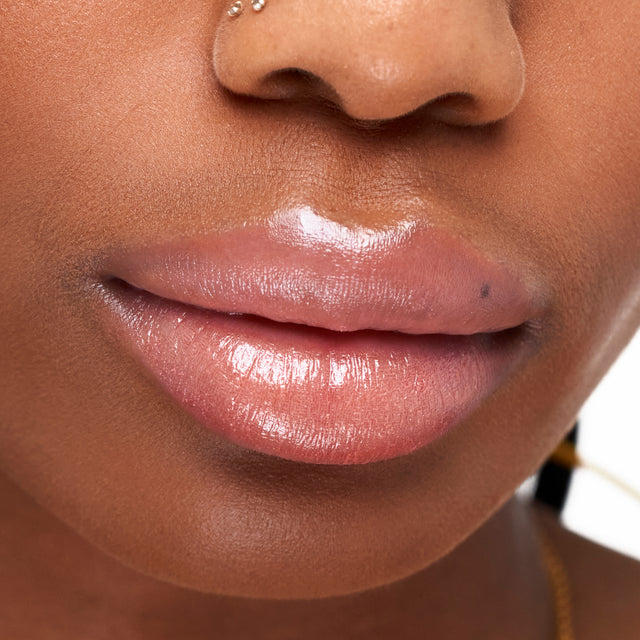 Deep skin tone model wearing Wet Stick in Heatwave