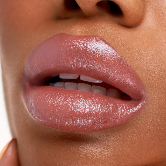Deep skin tone model wearing Weightless Lip Color in High Cut