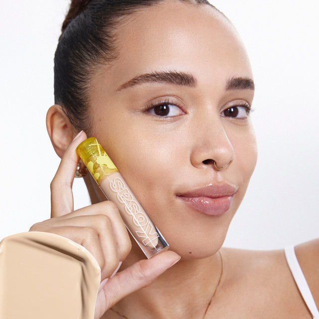 Model wearing Revealer Concealer in Tone 04 N