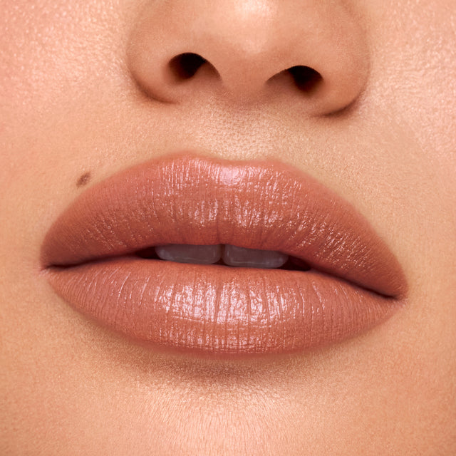 Medium skin tone model wearing Weightless Lip Color in Vegas