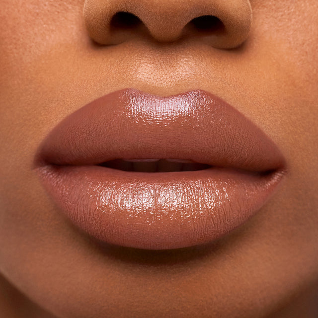 Deep skin tone model wearing Weightless Lip Color in Vegas