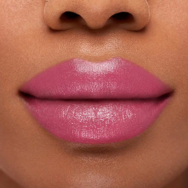 Deep skin tone model wearing Weightless Lip Color in Beach House