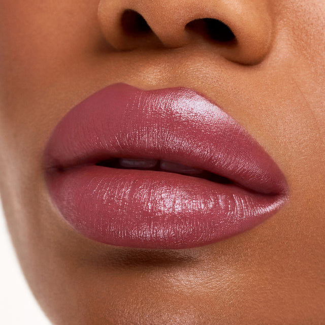 Deep skin tone model wearing Weightless Lip Color in Daydream