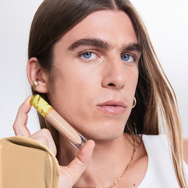 Model wearing Revealer Concealer in Tone 06 O