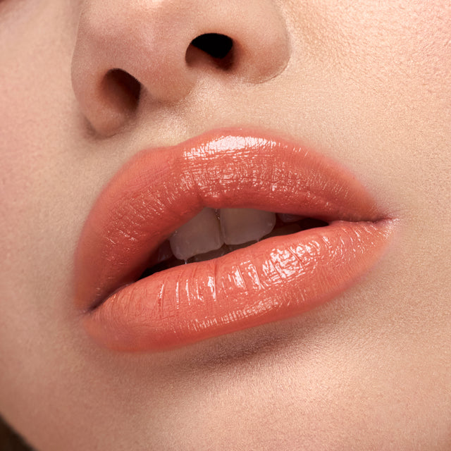 Light skin tone model wearing Wet Stick in Papaya Treat