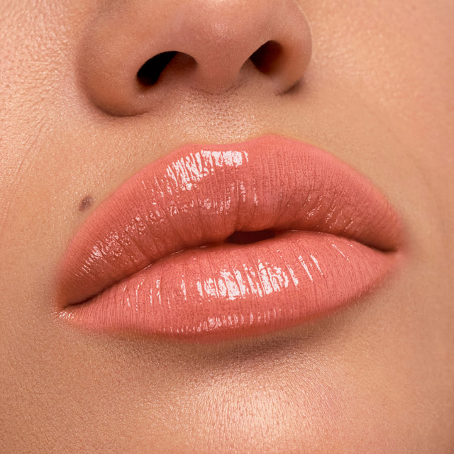 Medium skin tone model wearing Wet Stick in Papaya Treat