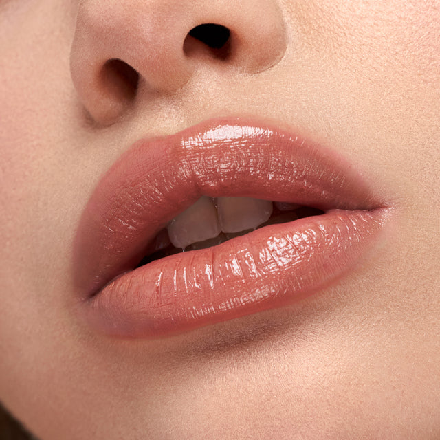 Light skin tone model wearing Wet Stick in 100 Degrees