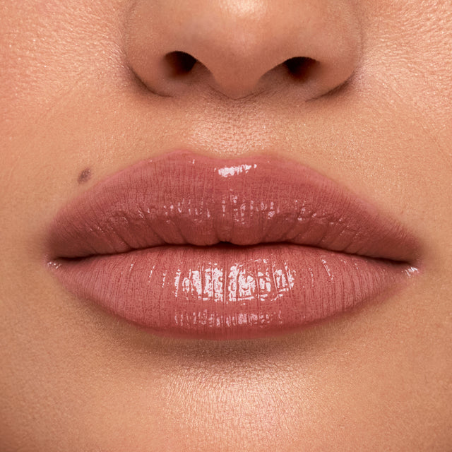 Medium skin tone model wearing Wet Stick in 100 Degrees