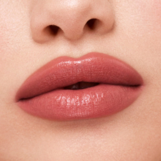 Light skin tone model wearing Weightless Lip Color in Turned On