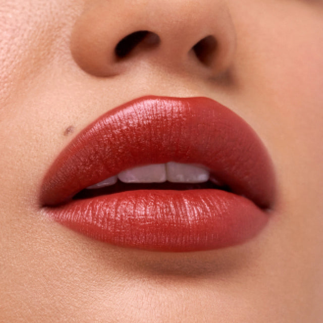Medium skin tone model wearing Weightless Lip Color in Deep Talks