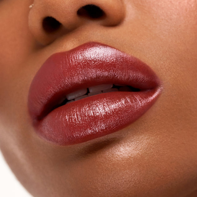 Deep skin tone model wearing Weightless Lip Color in Deep Talks