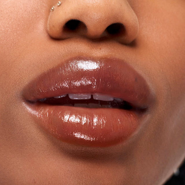 Deep skin tone model wearing Wet Stick in Sunset Simmer