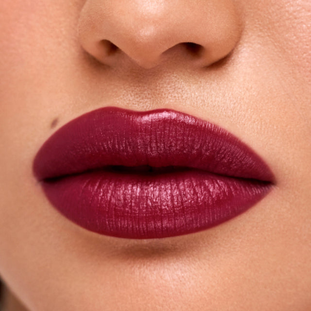 Medium skin tone model wearing Weightless Lip Color in Star Power