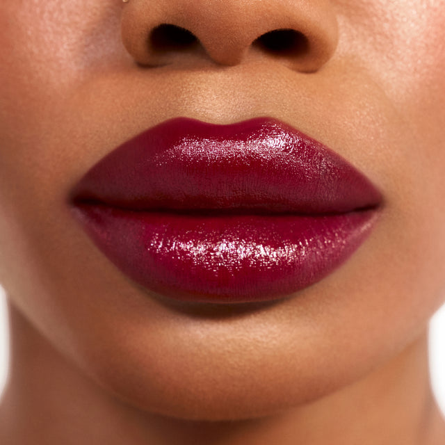Deep skin tone model wearing Weightless Lip Color in Star Power