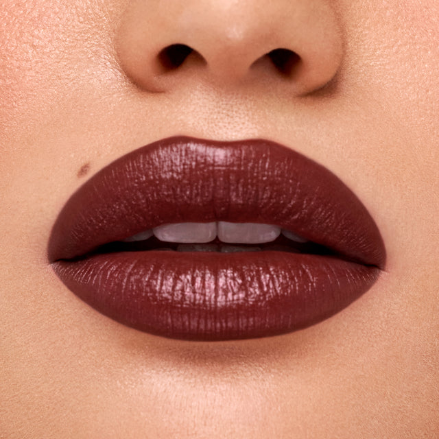 Medium skin tone model wearing Weightless Lip Color in Subconscious