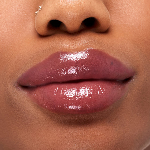 Deep skin tone model wearing Wet Stick in Tropic Bliss