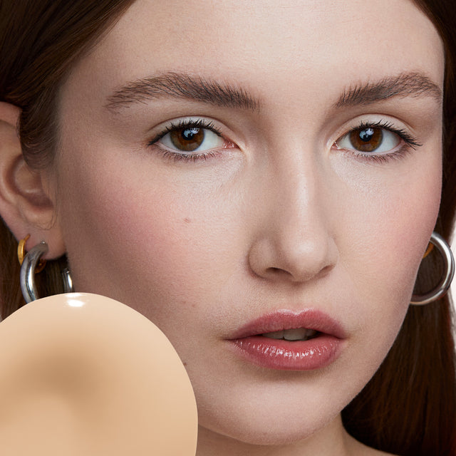 Model wearing Revealer Skin-Improving Foundation SPF 25 in Very Light Neutral 110