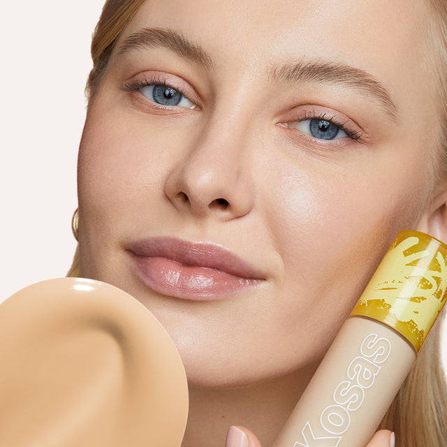 Model wearing Revealer Skin-Improving Foundation SPF 25 in Light Neutral Warm 130