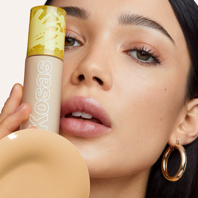 Model wearing Revealer Skin-Improving Foundation SPF 25 in Light+ Neutral Warm 170