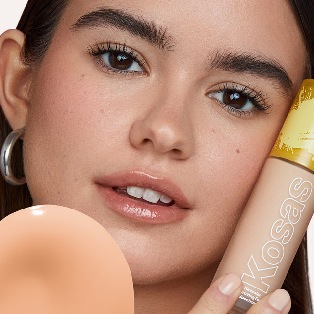 Model wearing Revealer Skin-Improving Foundation SPF 25 in Light+ Cool 180