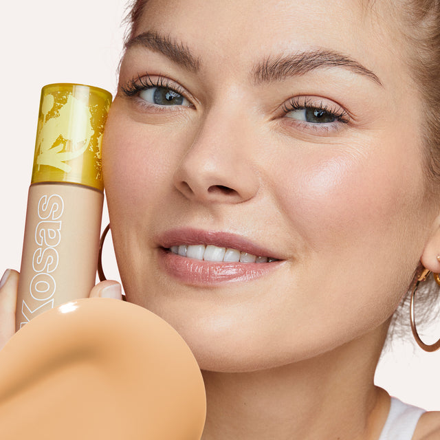 Model wearing Revealer Skin-Improving Foundation SPF 25 in Light Medium Neutral Warm 190