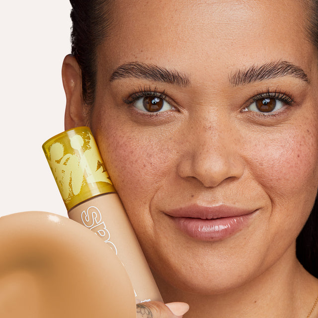 Model wearing Revealer Skin-Improving Foundation SPF 25 in Medium Warm 240