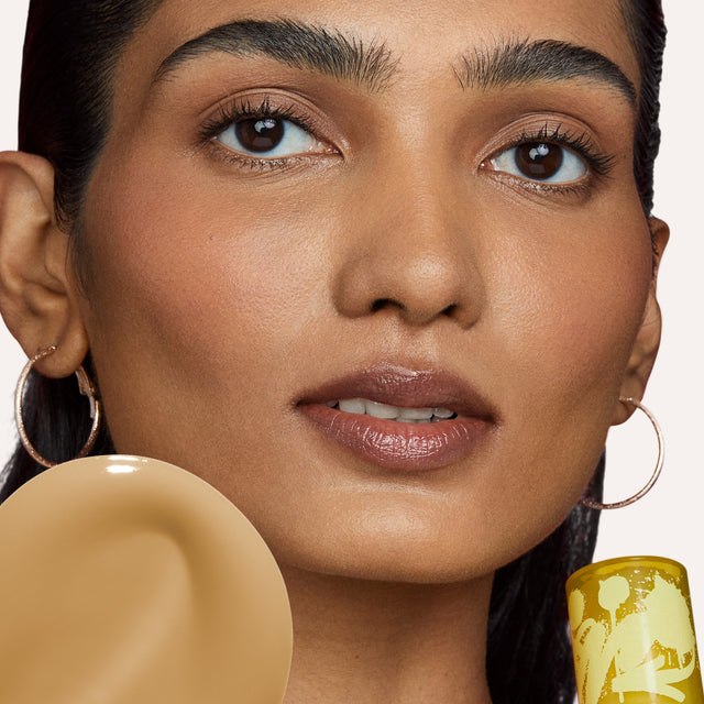 Model wearing Revealer Skin-Improving Foundation SPF 25 in Medium Tan Olive 270