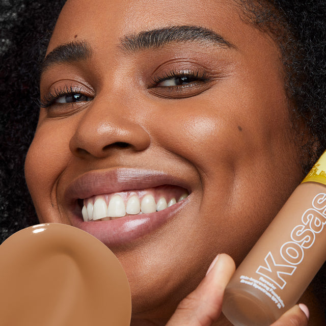 Model wearing Revealer Skin-Improving Foundation SPF 25 in Medium Deep Neutral Warm 330