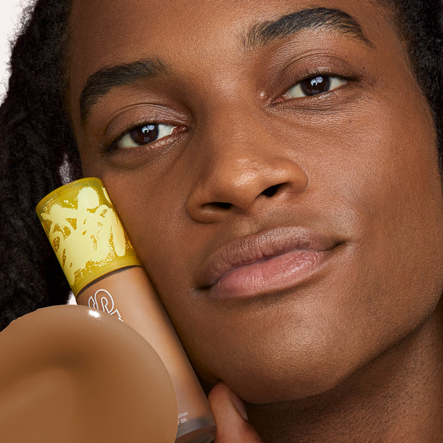 Model wearing Revealer Skin-Improving Foundation SPF 25 in Medium Deep Neutral Olive 360