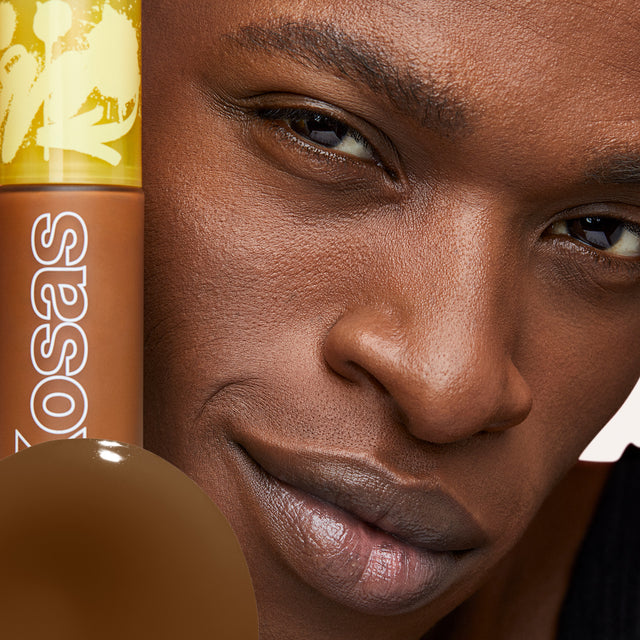 Model wearing Revealer Skin-Improving Foundation SPF 25 in Deep Neutral Olive 400