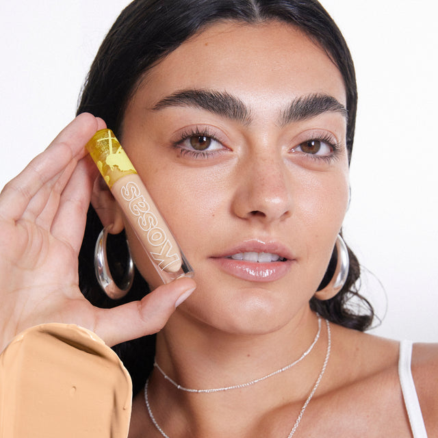 Model wearing Revealer Concealer in Tone 5.8 N