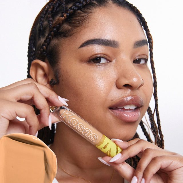 Model wearing Revealer Concealer in Tone 6.8 W