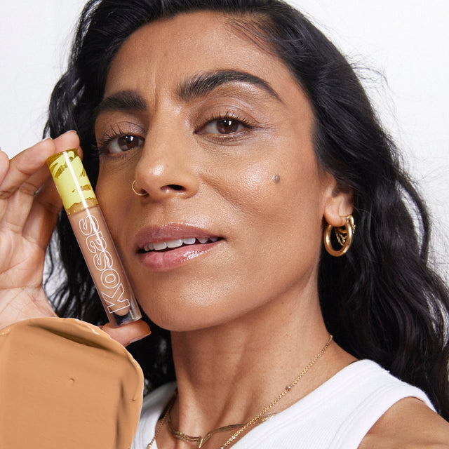 Model wearing Revealer Concealer in Tone 7.3 N