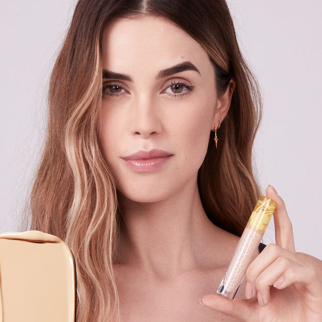 Model wearing Mini Revealer Concealer in Tone 03 W