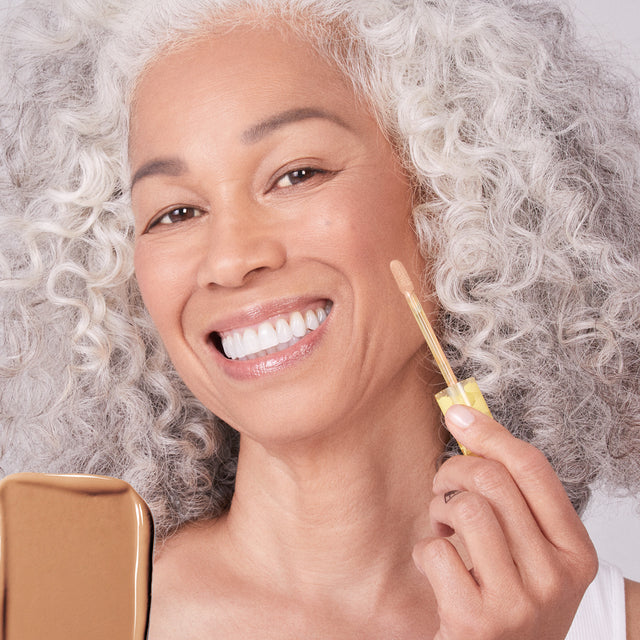 Model wearing Mini Revealer Concealer in Tone 07 N