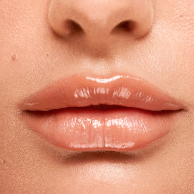Light skin tone model wearing Wet Lip Oil Gloss in Bare