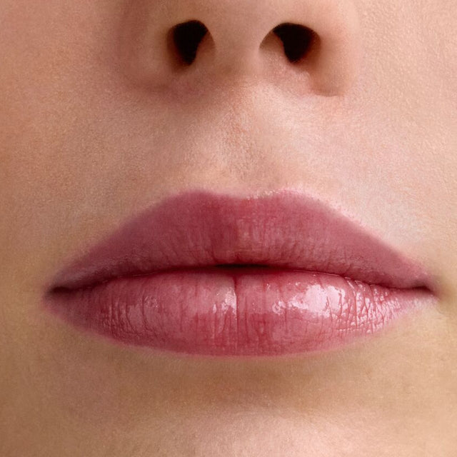 Light skin tone model wearing Wet Lip Oil Gloss in Cola