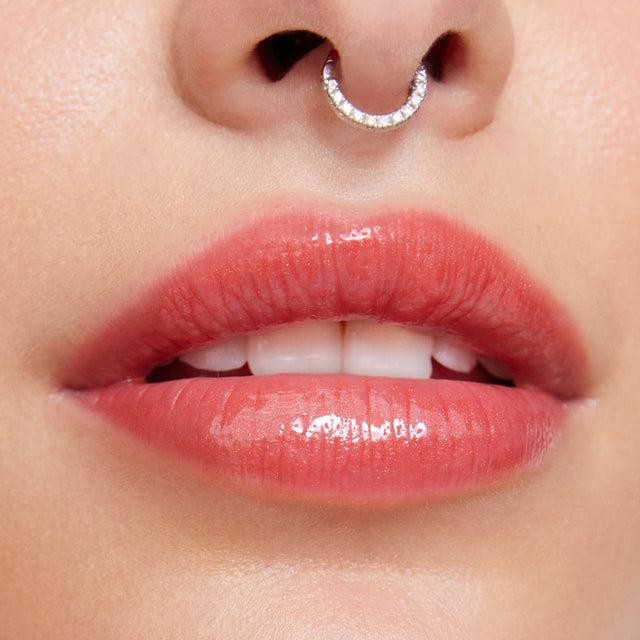 Light skin tone model wearing Wet Lip Oil Gloss in Dip