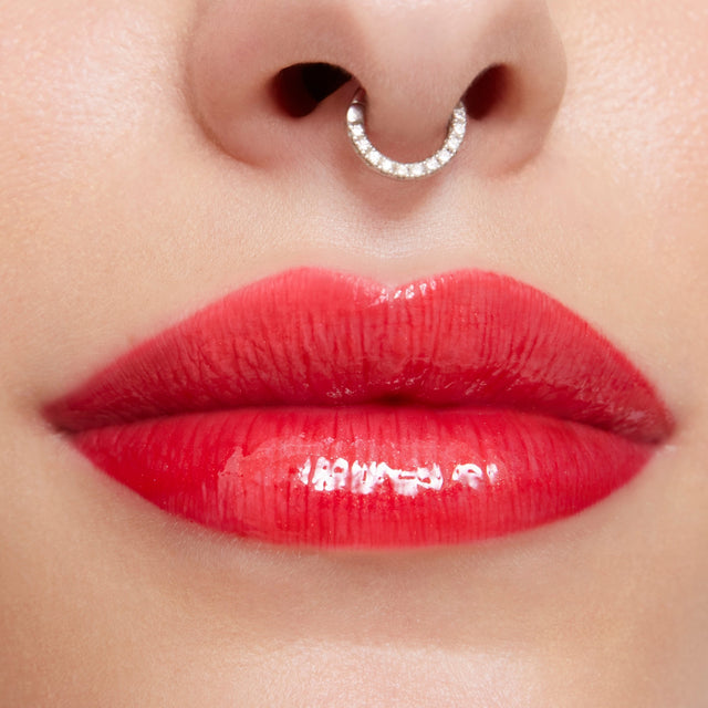 Light skin tone model wearing Wet Lip Oil Gloss in Jaws