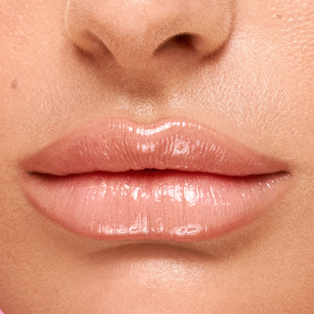 Light skin tone model wearing Wet Lip Oil Gloss in Revealed