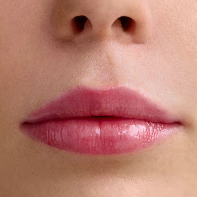 Light skin tone model wearing Wet Lip Oil Gloss in Slushy