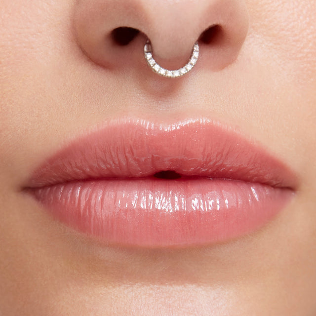 Light skin tone model wearing Wet Lip Oil Gloss in Unbuttoned