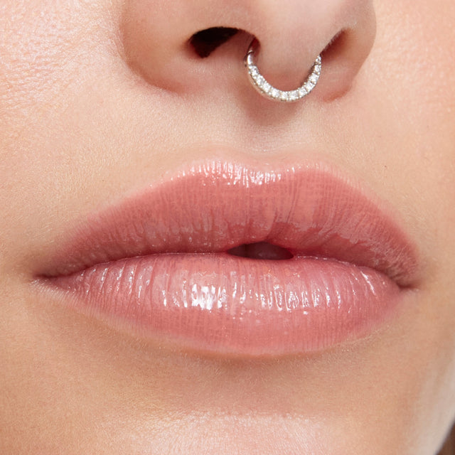 Light skin tone model wearing Wet Lip Oil Gloss in Unhooked