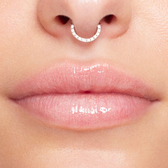 Light skin tone model wearing Wet Lip Oil Gloss in Unzipped