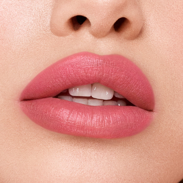 Light skin tone model wearing Weightless Lip Color in Rosewater