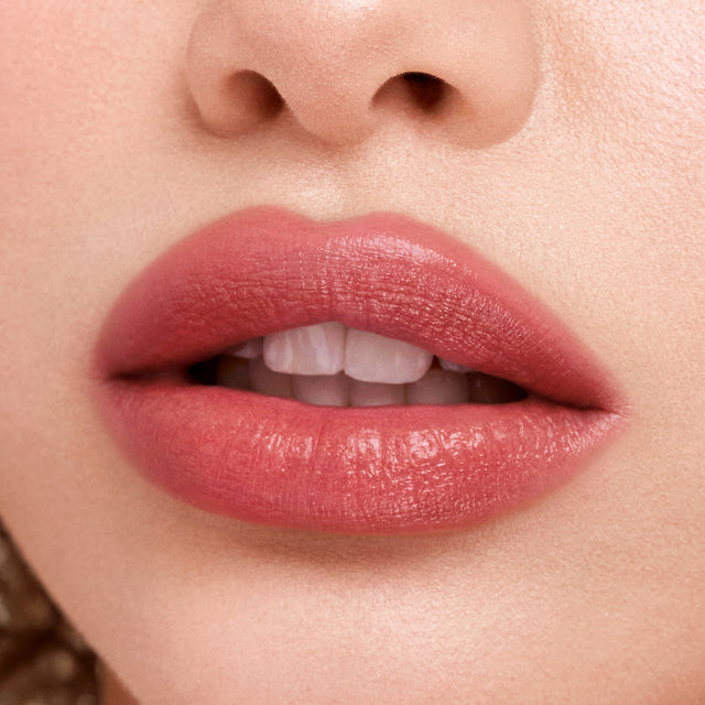 Light skin tone model wearing Weightless Lip Color in Stardust