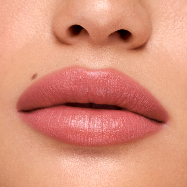 Medium skin tone model wearing Weightless Lip Color in Stardust